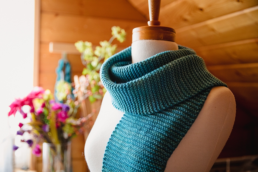 Modeled view of a garter stitch scarf, worked in SweetGeorgia Superwash Worsted and perfect for first time knitters